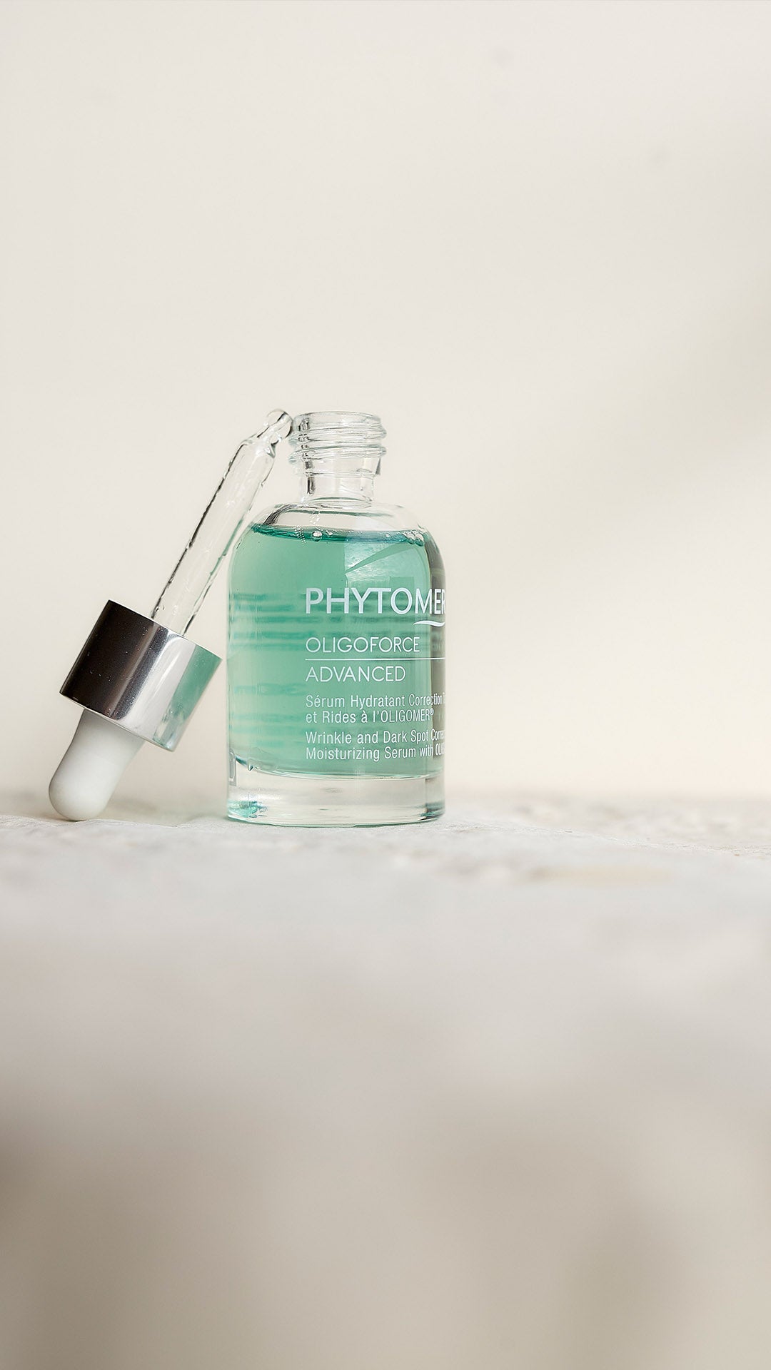 Bottle of Phytomer serum with dropper on a light background