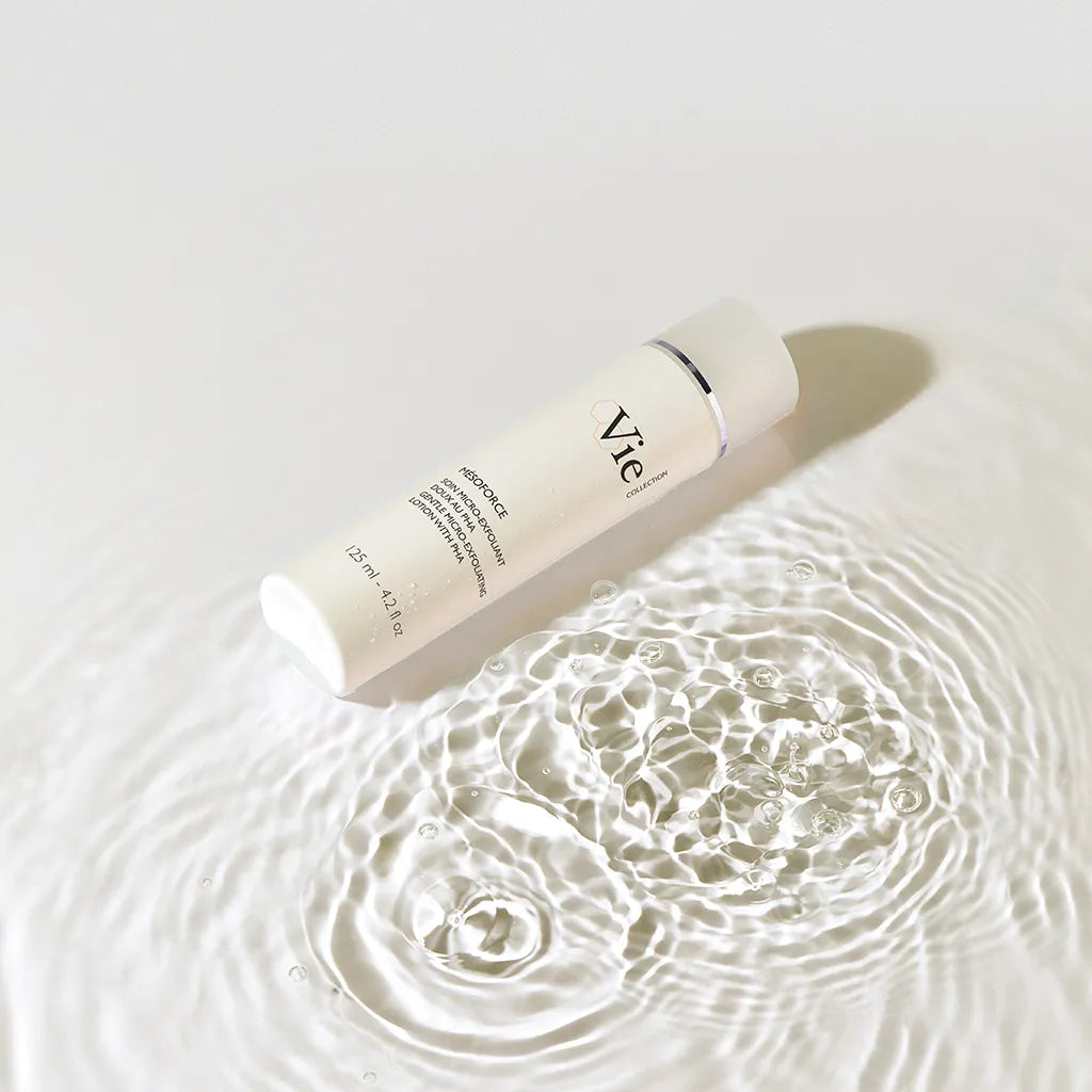 Skincare bottle with 'Vie' branding on a water surface