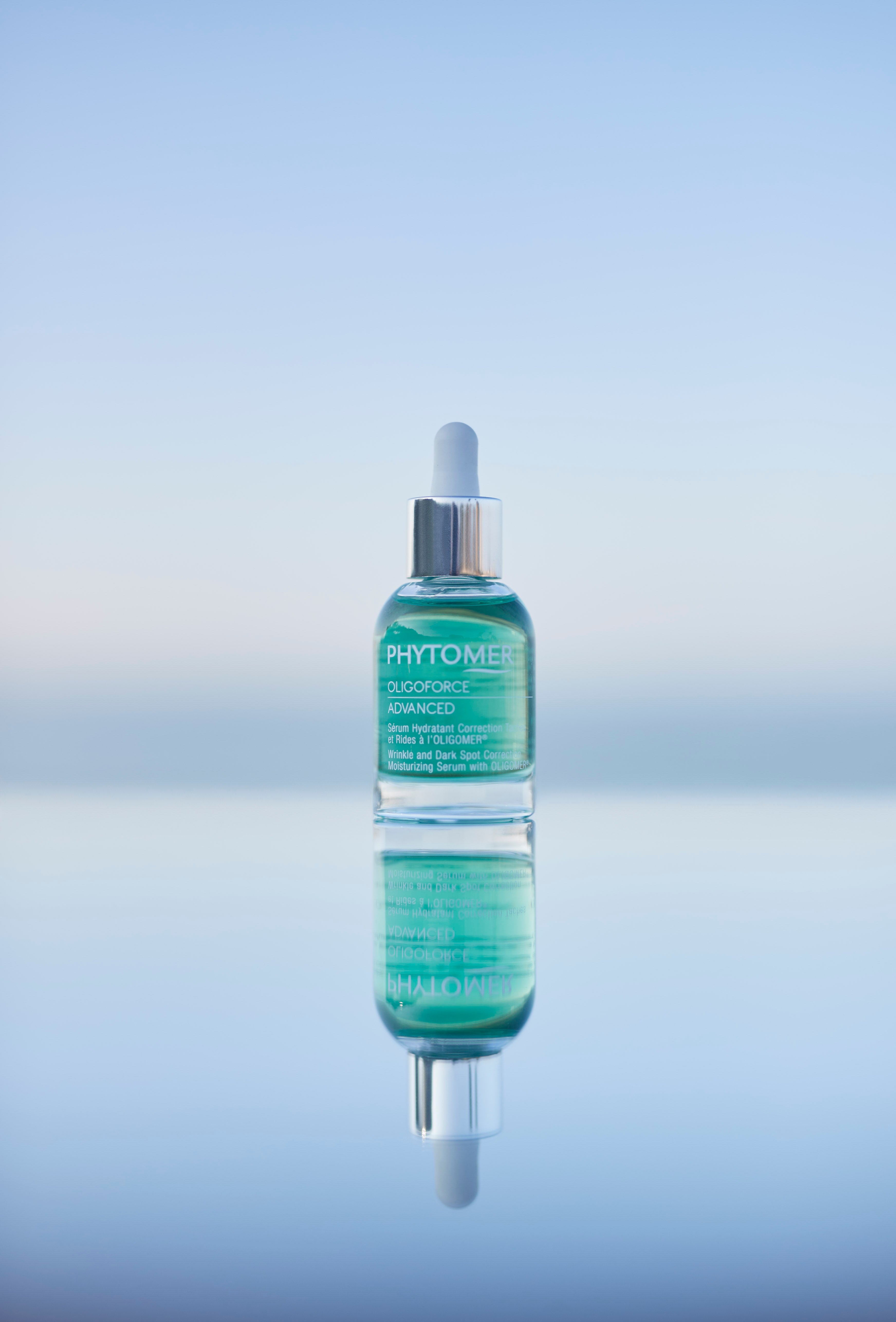 Bottle of Phytomer skincare serum on a gradient blue background