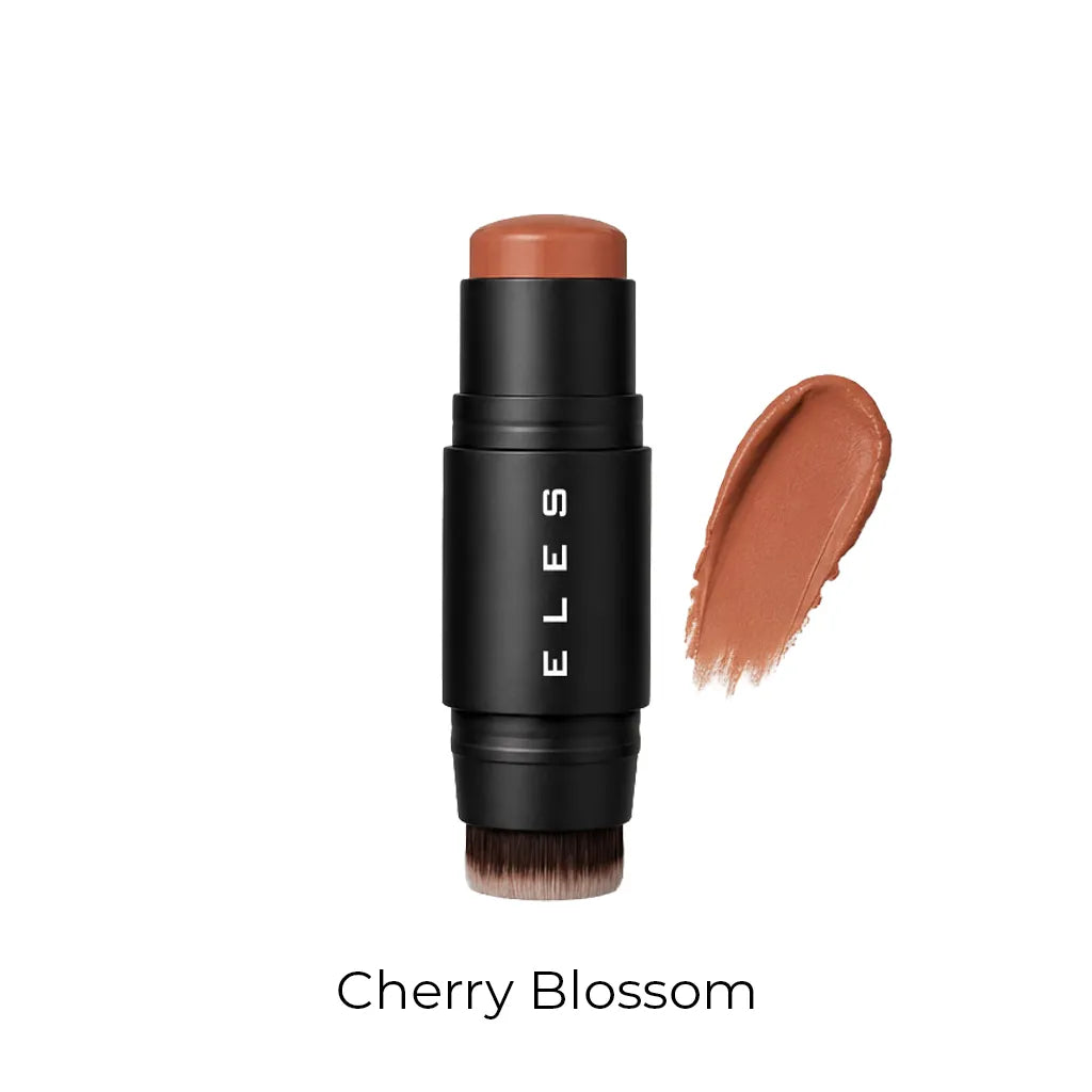 ELES Cheek & Lip Cream Blush in the shade Cherry Blossom, featuring a matte black cylindrical stick with white brand lettering and an integrated blending brush at the base. A warm terracotta-brown cream swatch is shown to the right, with the shade name Cherry Blossom printed below on a white background.