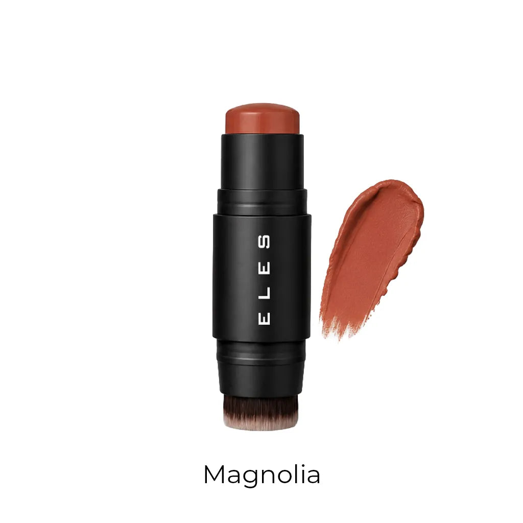 ELES cheek and lip cream in the shade Magnolia, featuring a matte black barrel with white brand lettering and a warm terracotta-brown cosmetic product exposed at the top. A matching textured swipe of the cream product is shown to the right, with the shade name 'Magnolia' printed below on a clean white background.