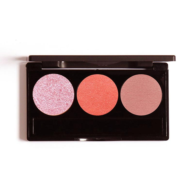 A palette containing three shades of eyeshadow, with one pink, one orange, and one brown shade, arranged in a row.