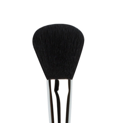 A close-up image of a flat powder blush brush with Taklon bristles and a silver metal handle.