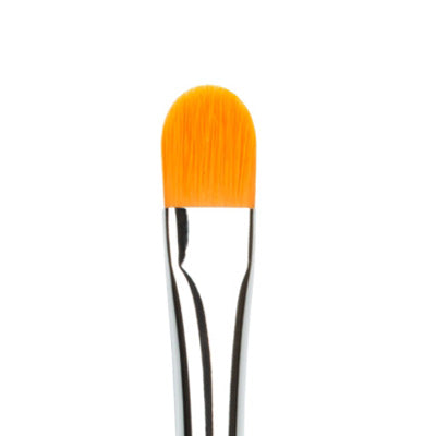A close-up image of a small concealer brush with a silver metal handle and orange synthetic bristles shaped for makeup application.