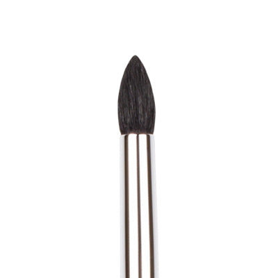 A close-up image of a small tapered blending brush with a pointed tip made of synthetic bristles and a metallic silver handle.