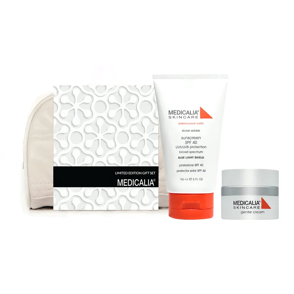 A Medicalia Skincare limited edition Gentle Cream gift set on a white background, featuring a white patterned box with a black band, a white sunscreen tube with an orange cap, and a white cream jar with a gray lid.
