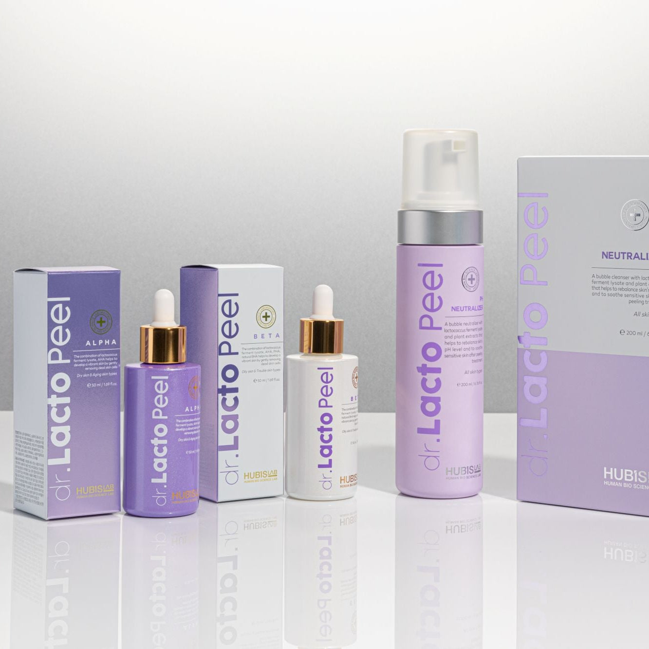 Lacto Peel skincare products including bottles and boxes on a reflective surface with a gray background
