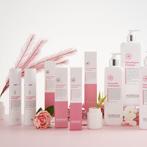 Hubislab post rays line skincare products on a pink surface with flowers and leaves.