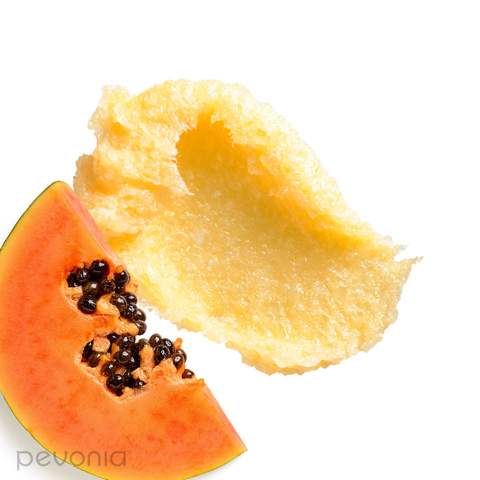 Pevonia De-Aging Saltmousse Papaya Pineapple cream Halved papaya on a white background to show Texture-and-ingredients