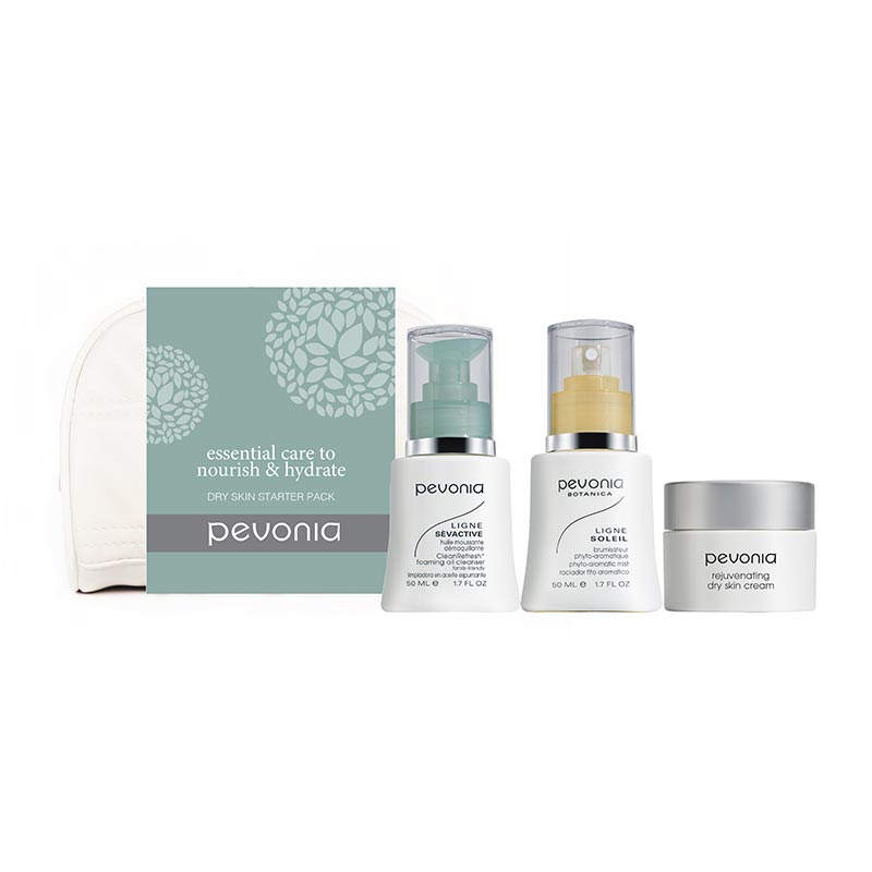 A skincare starter kit by Pevonia, including a foaming oil cleanser, aromatic hydrating mist, and dry skin cream, presented in travel-sized containers.