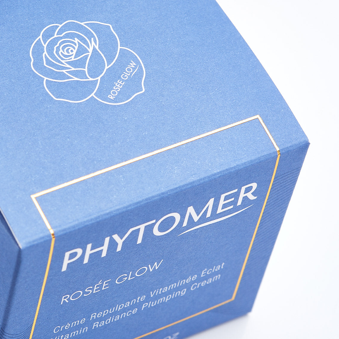 Blue box of Phytomer Rosée Glow cream with a rose design on a white background