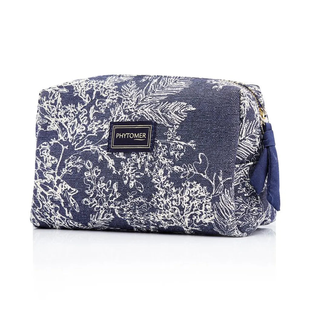 Navy toiletry bag with white floral pattern and Phytomer logo on a white background