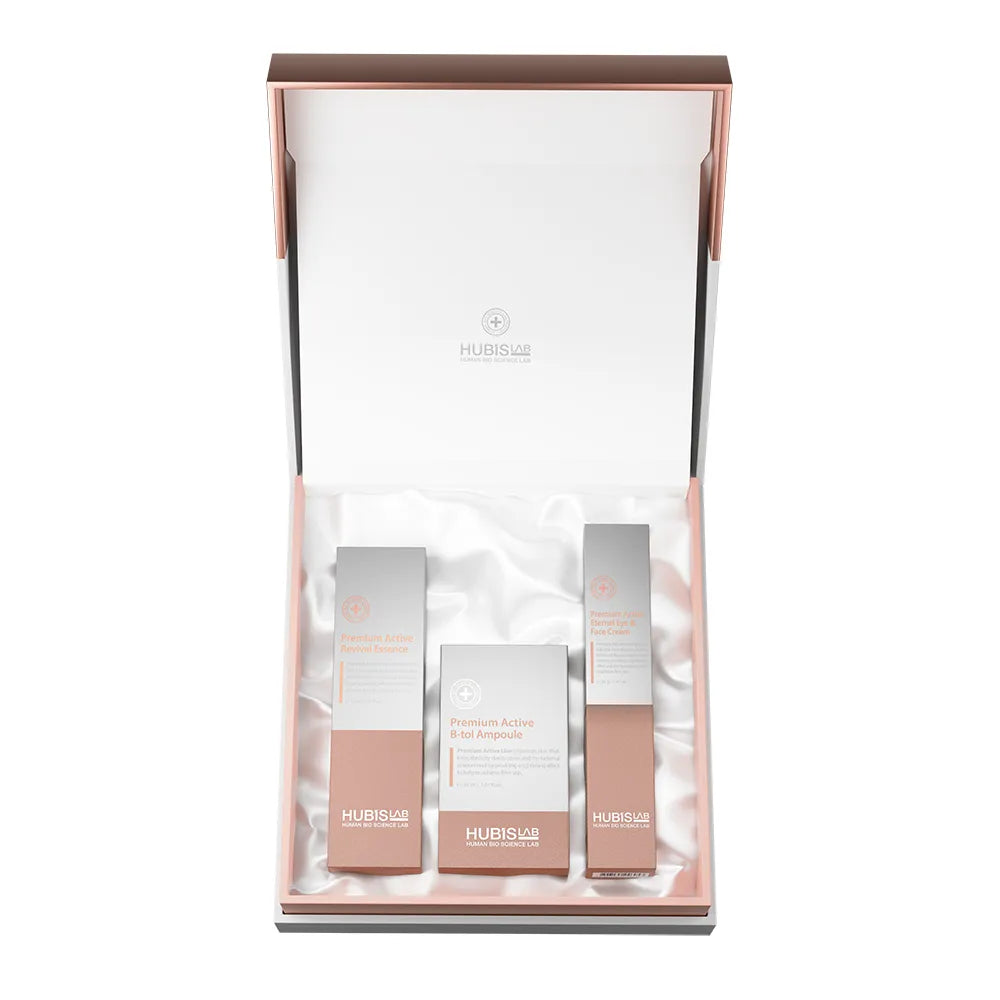 A HUBISLAB skincare gift set displayed in an open rose gold and black presentation box lined with white satin. 