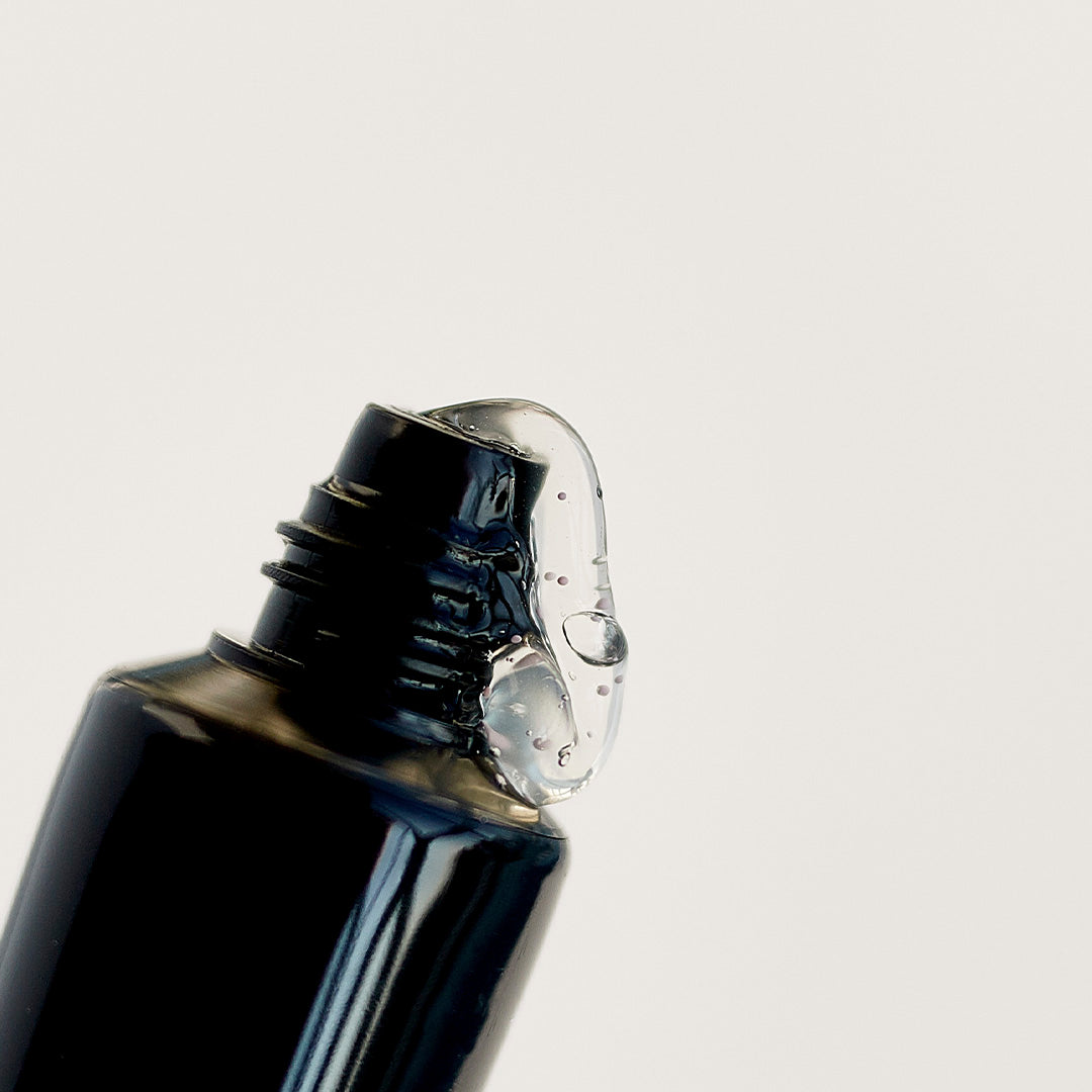 Close-up of a black bottle cap on a light gray background