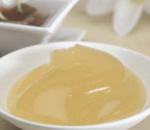 Yellow gel-like Waterlily product in a white bowl on a blurred background