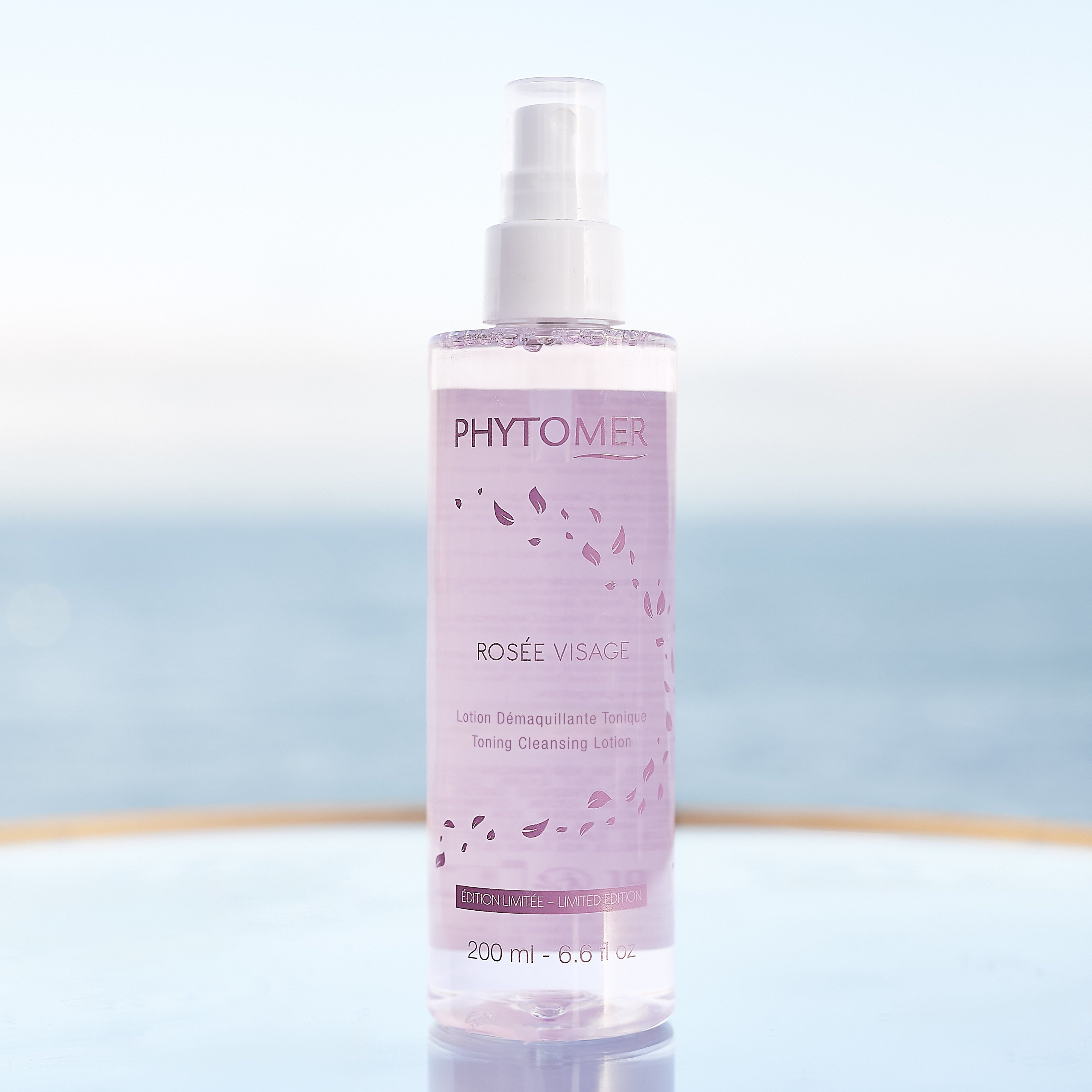 Phytomer bottle of Rosé Visage on a reflective surface with a blurred background