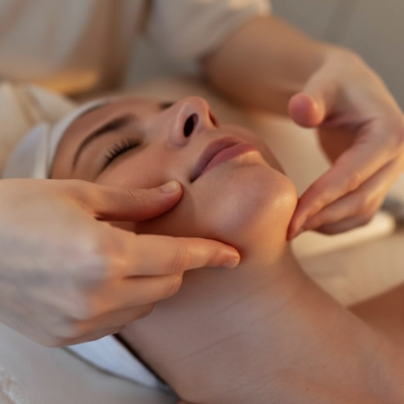 Person receiving a facial massage in a spa setting
