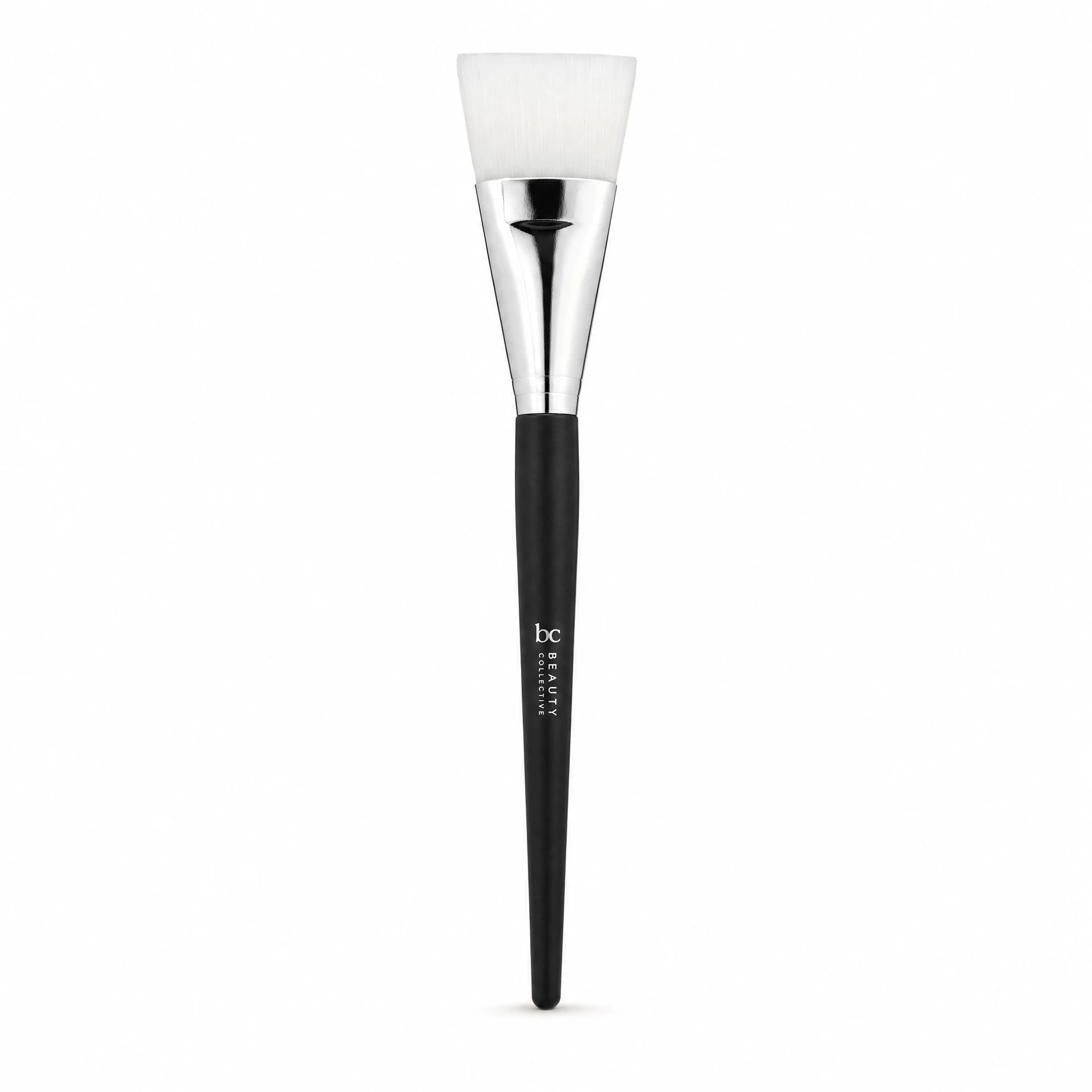 Beauty Collective Face Mask Brush Full Size on white background, flat angled synthetic bristle head, silver chrome ferrule and matte black handle, professional skincare tool