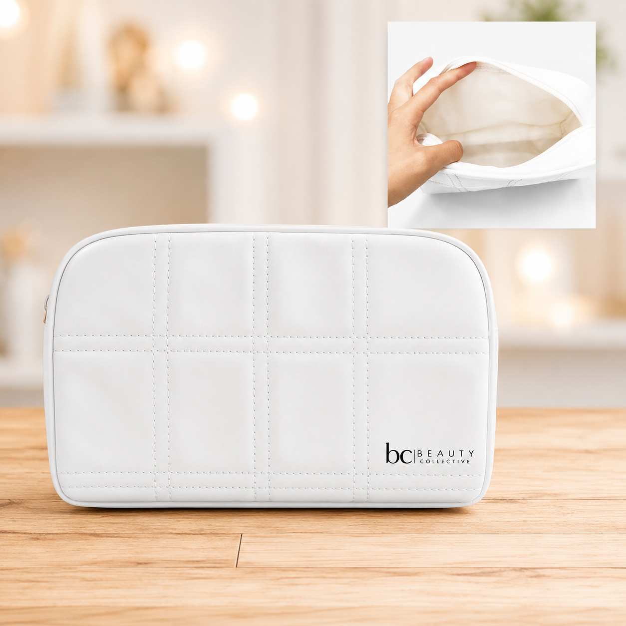 Beauty Collective white quilted cosmetic bag displayed on a wooden surface with a soft lifestyle background.