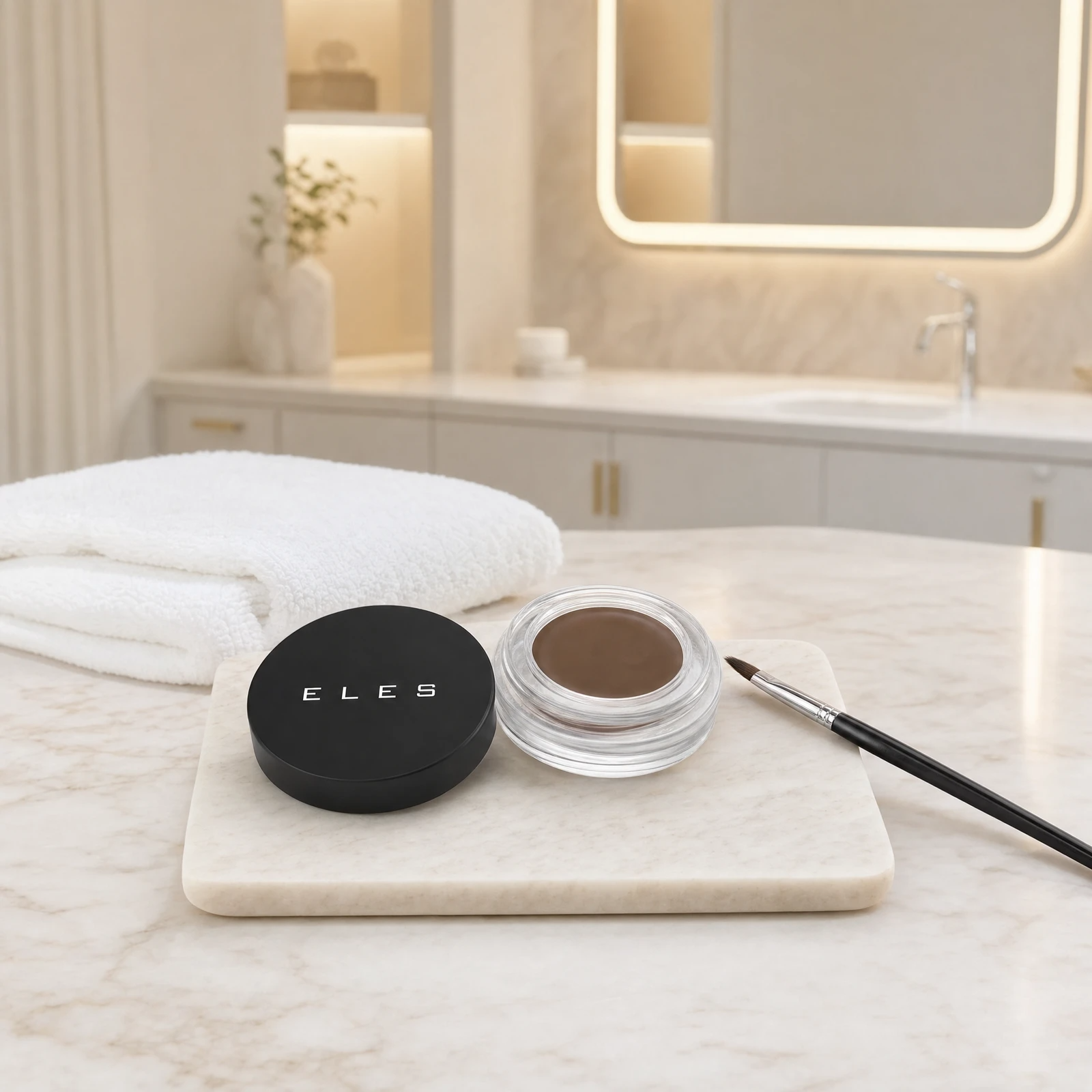 ELES Brow Balm Pomade open jar with lid and angled brow brush on a stone tray on a marble clinic bench inside a premium skin clinic treatment room, ideal for professional brow definition after facial treatments