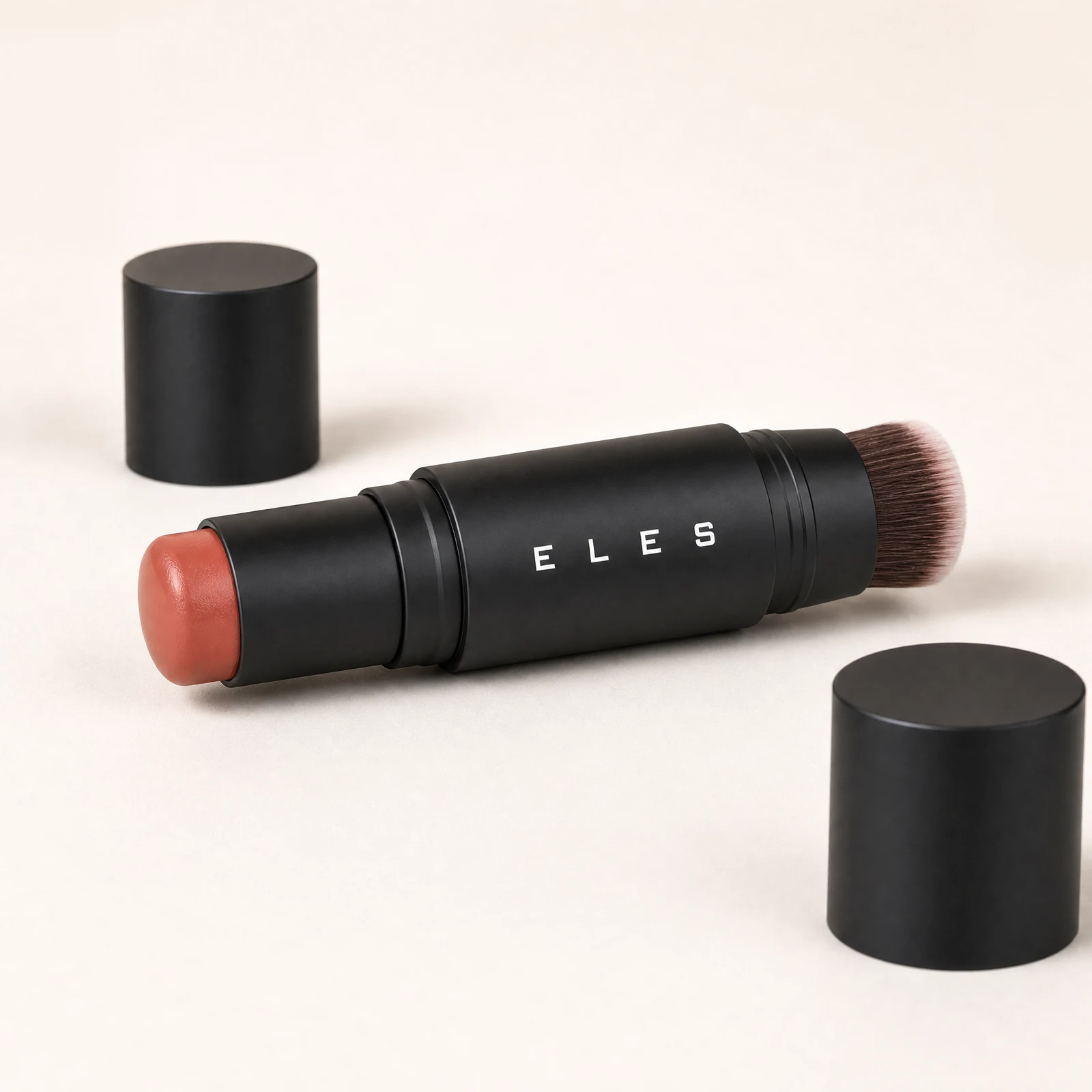 Close-up of the ELES dual-ended cheek and lip cream stick showing the colour bullet, twist mechanism and built-in blending brush.