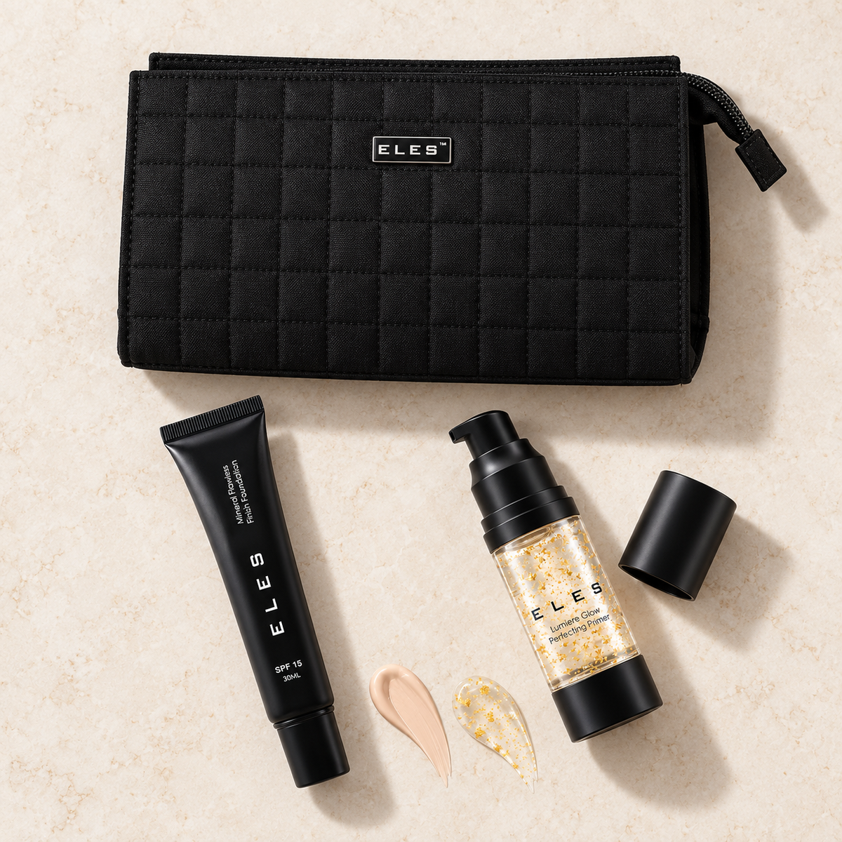 Overhead arrangement of ELES foundation, primer and cosmetics bag with foundation and gold-flecked primer textures.