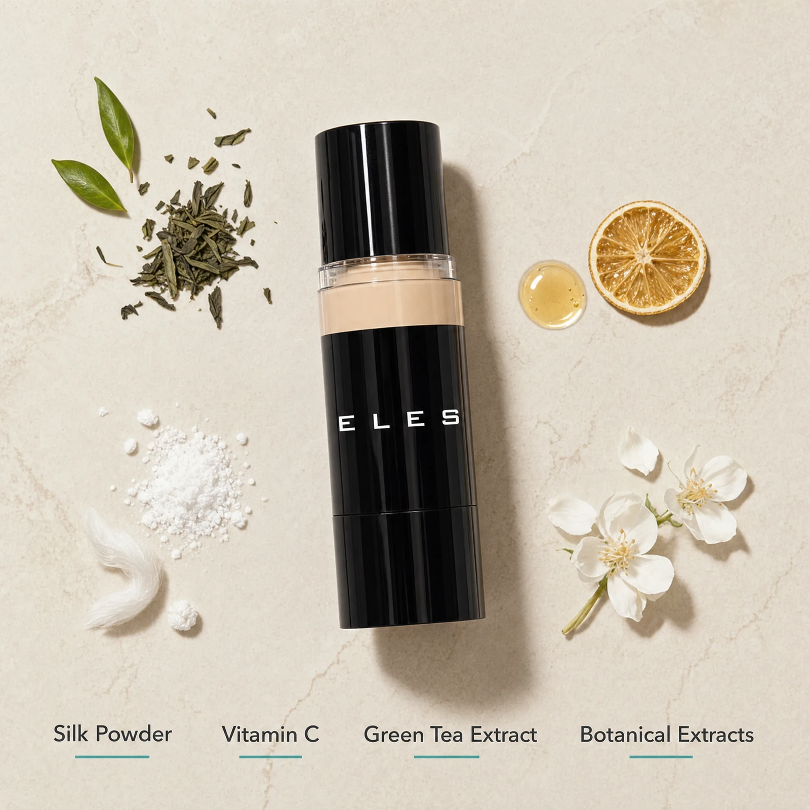 ELES HD Luminous Foundation ingredient flatlay featuring silk powder, vitamin C, green tea extract and botanical extracts on a warm limestone surface