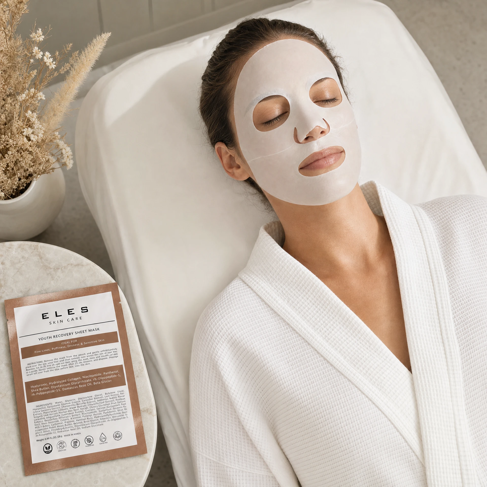 ELES Skin Care Professional Strength Sheet Mask applied during a clinical skincare treatment, woman relaxing on treatment bed in white robe, upmarket clinic setting
