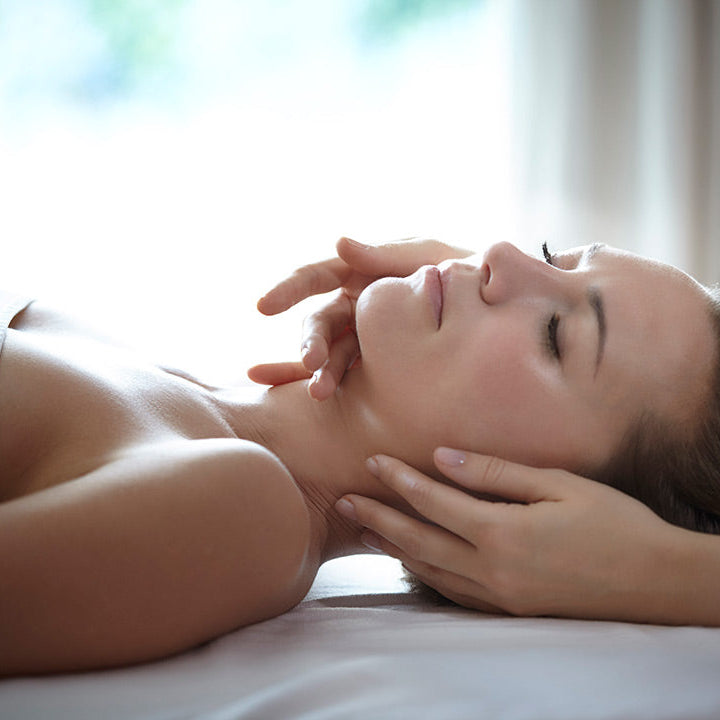 Woman receiving a neck massage in a spa setting
