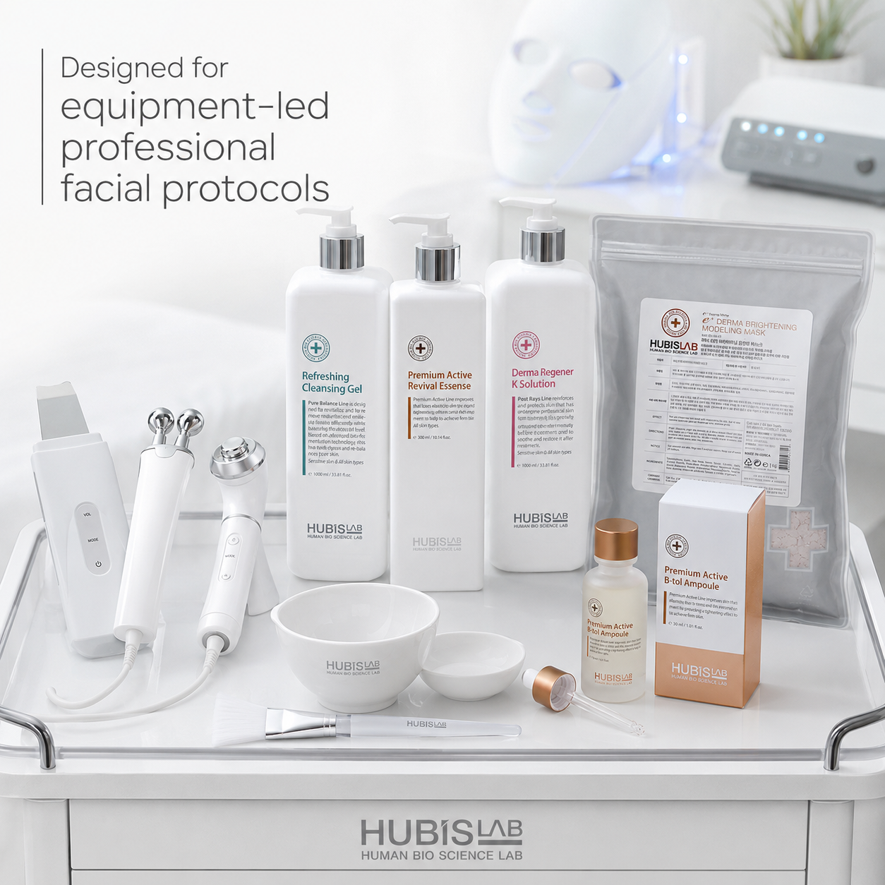 Hubislab Antioxidant Program professional facial protocol setup with skincare equipment, treatment bowls, brush, B-tol Ampoule, modelling mask and supporting treatment products on a clinical trolley.