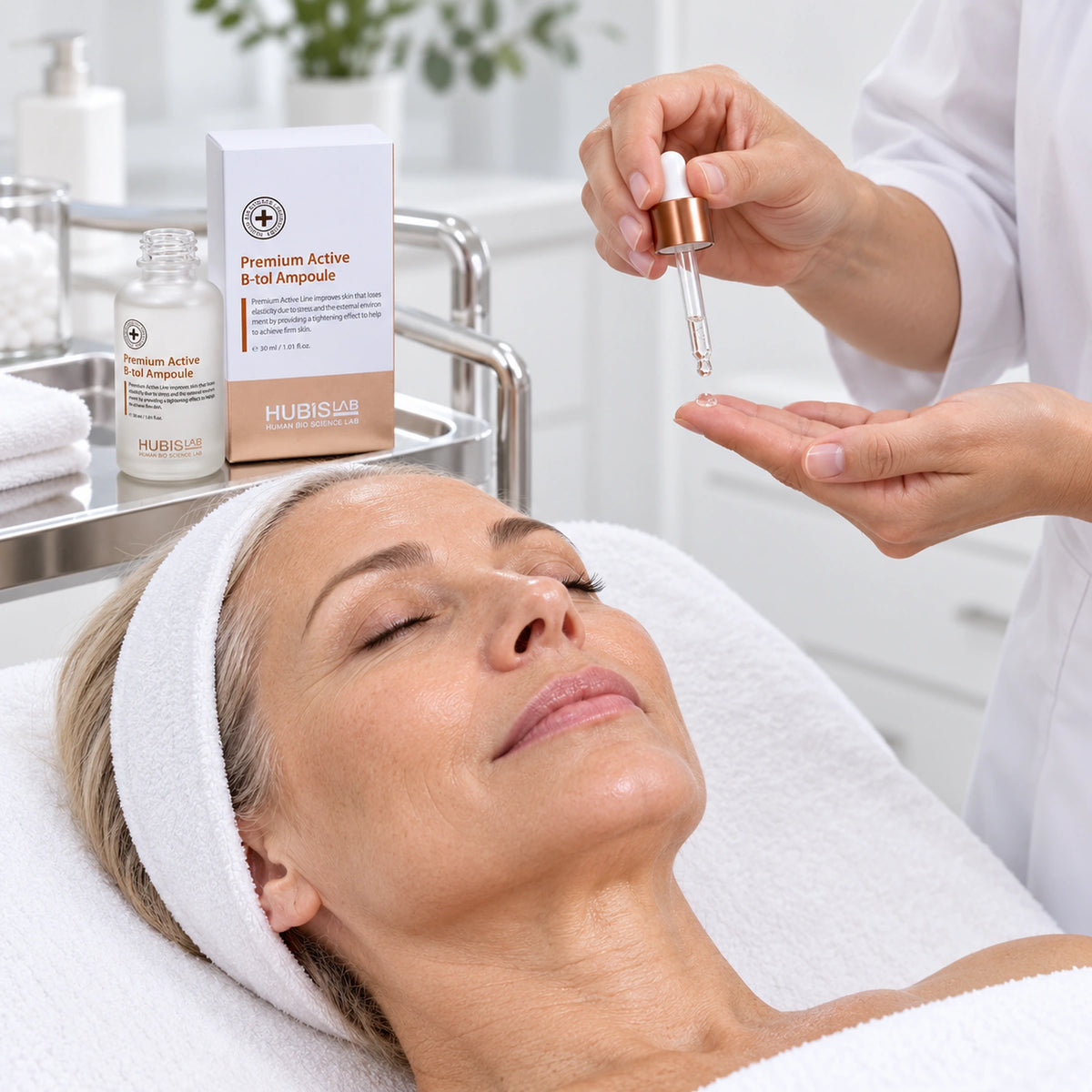 Therapist preparing B-tol Ampoule 30 ml for topical facial application.