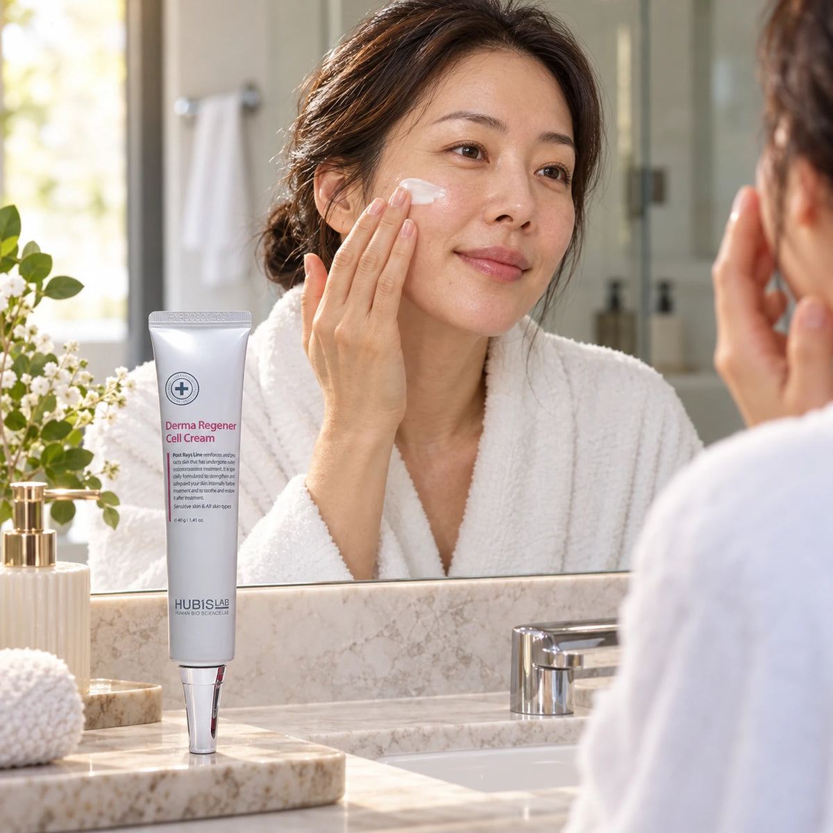 Client applying moisturising cream at home beside HUBISLAB Derma Regener Cell Cream 40 g.