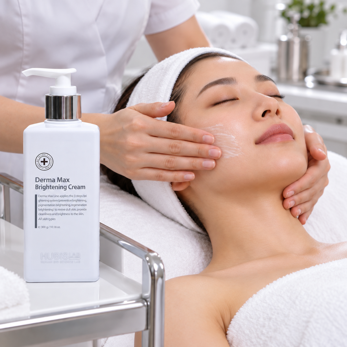Therapist gently spreading a thin layer of HUBISLAB Brilliance Cream over a client’s cheek during facial finishing.
