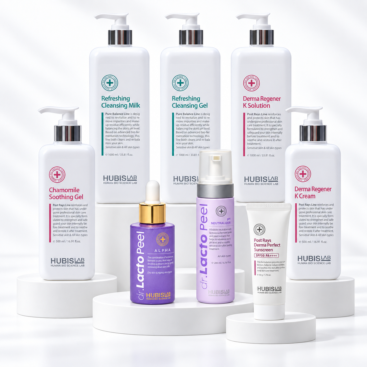 Eight HUBISLAB products for the Dr. Lacto Peel Alpha treatment arranged on white display stands.