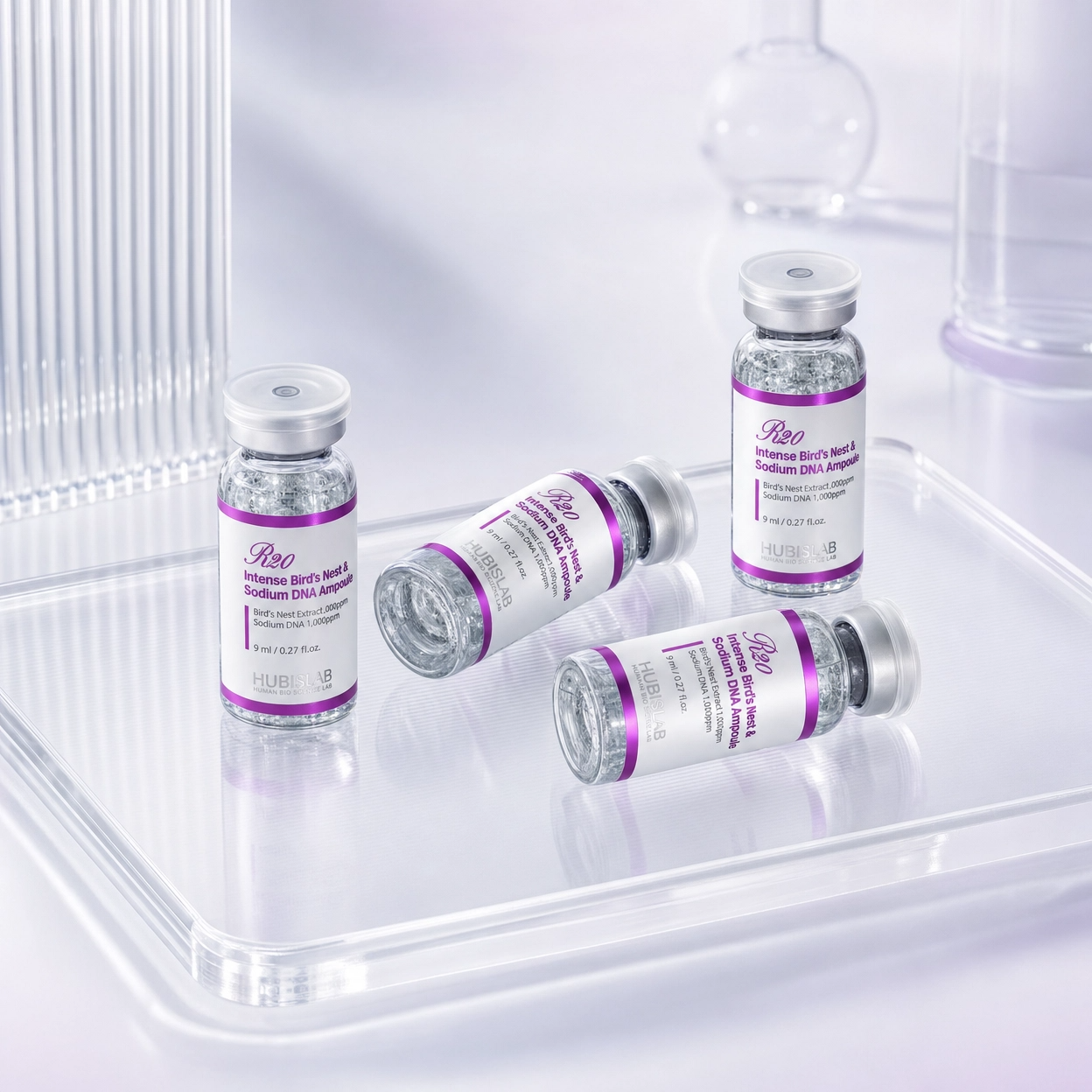 Hubislab R20 Intense Bird’s Nest and Sodium DNA Ampoule vials on a clear clinical tray for professional skincare treatments