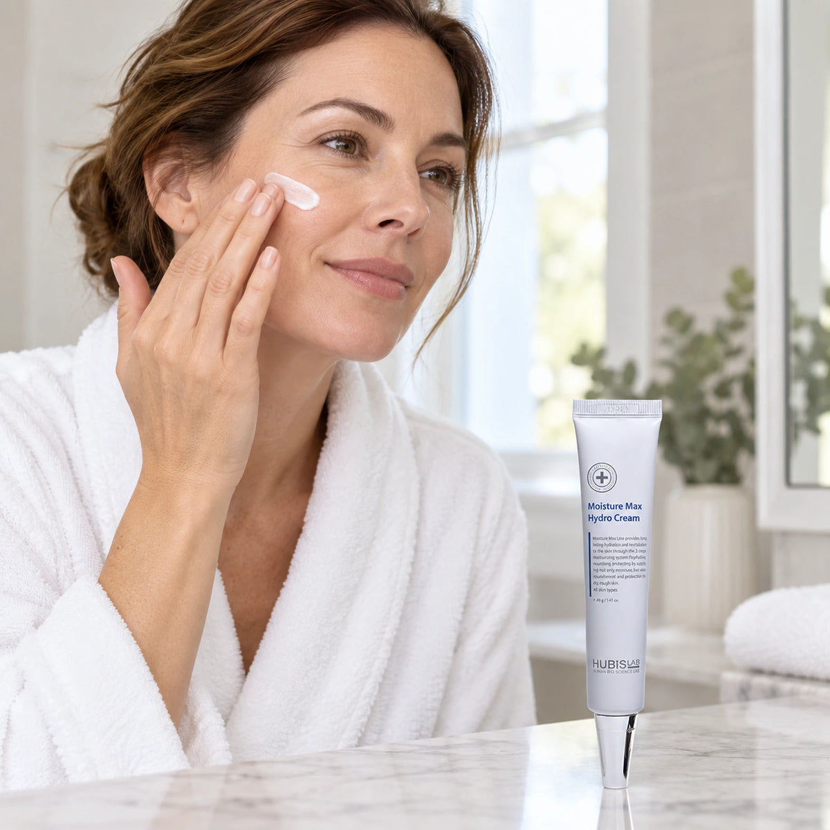 Woman applying moisturiser beside HUBISLAB Moisture Max Hydro Cream 40 g