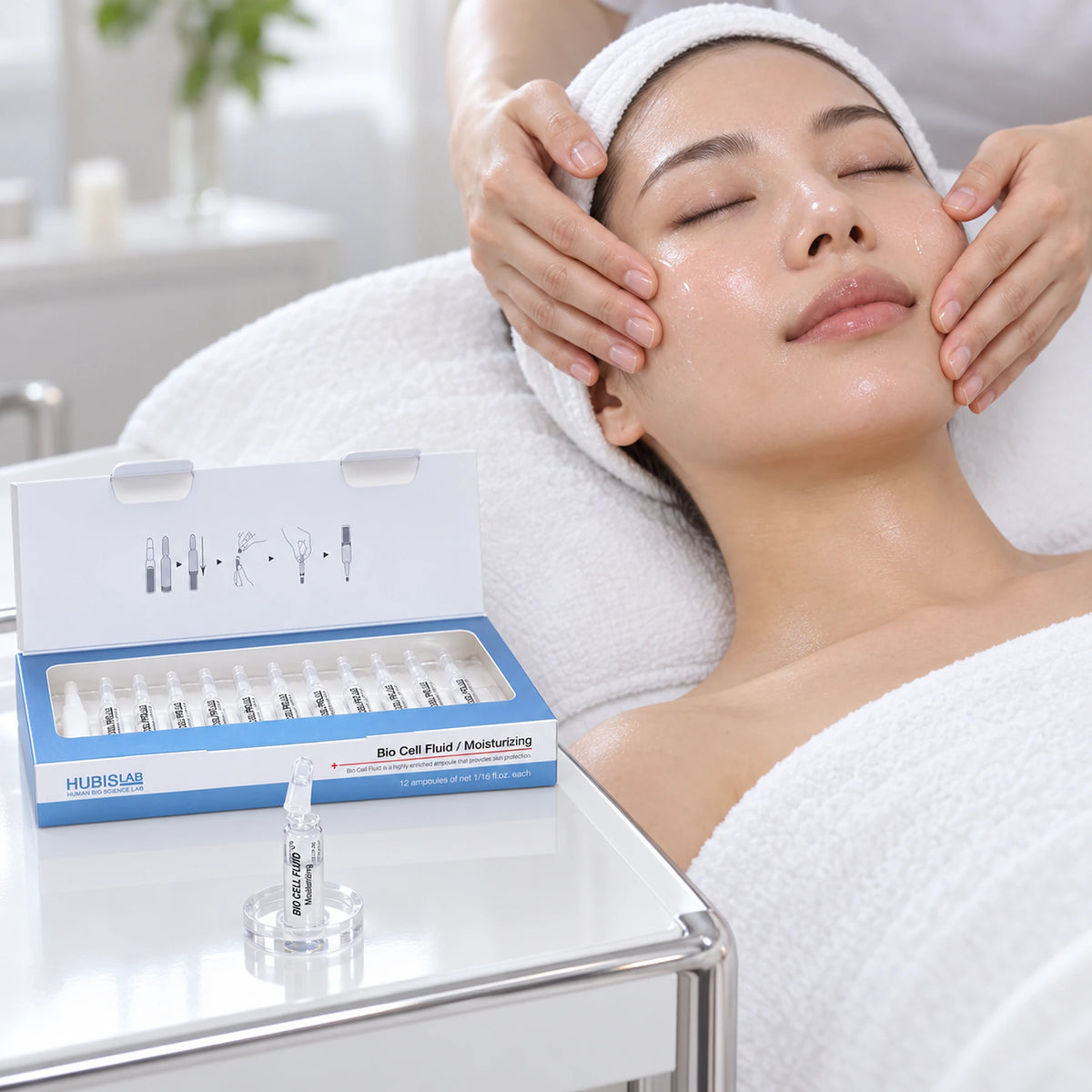 Therapist applying hydration care to a client’s face beside HUBISLAB Bio Cell Moisturizing Fluid ampoules.