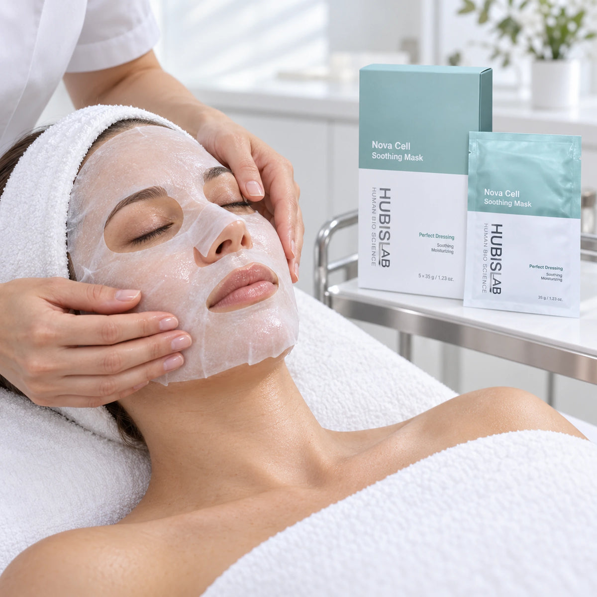 Therapist smoothing a Nova Cell Soothing sheet mask during a facial