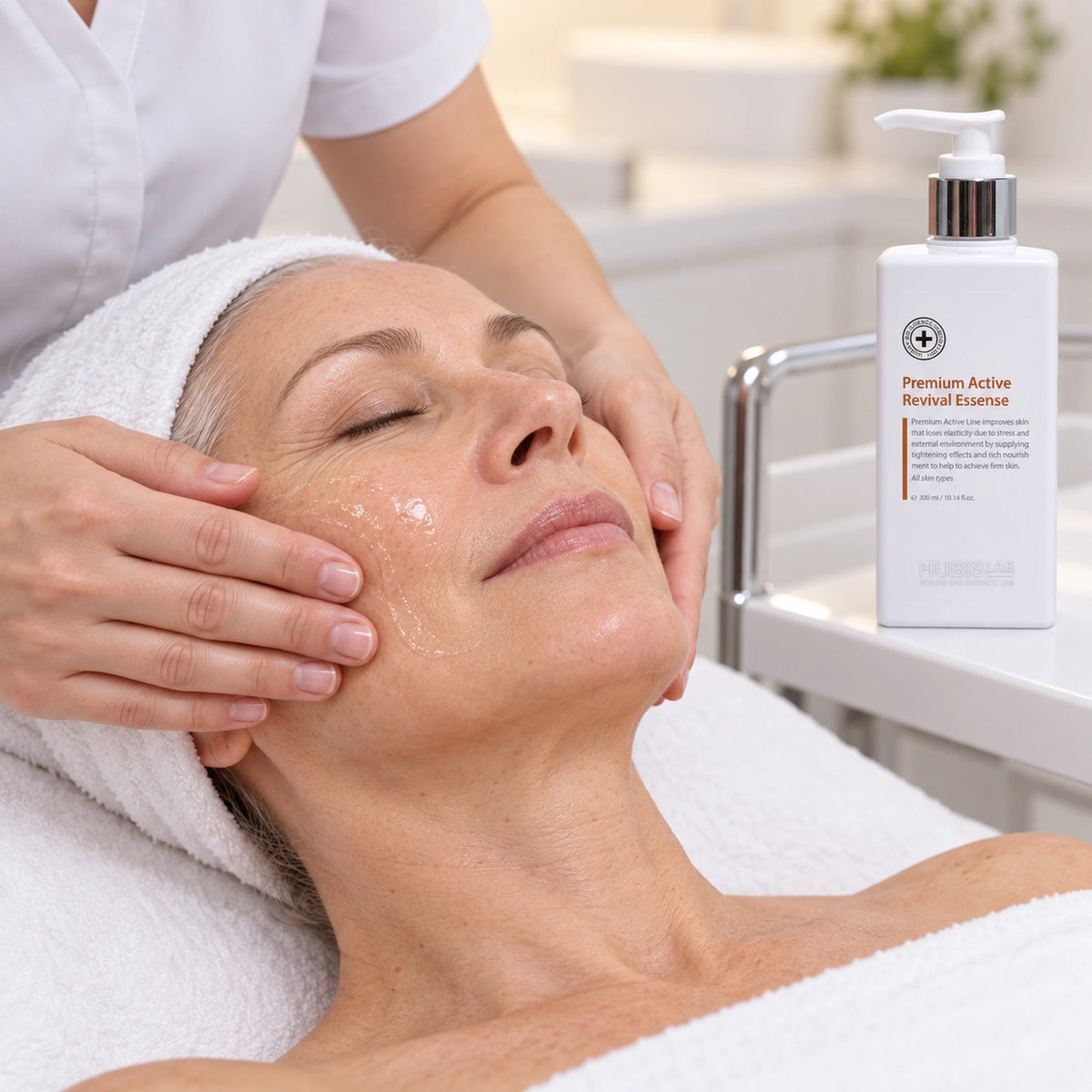 Therapist applying HUBISLAB revival essence with the 300 ml presentation shown.