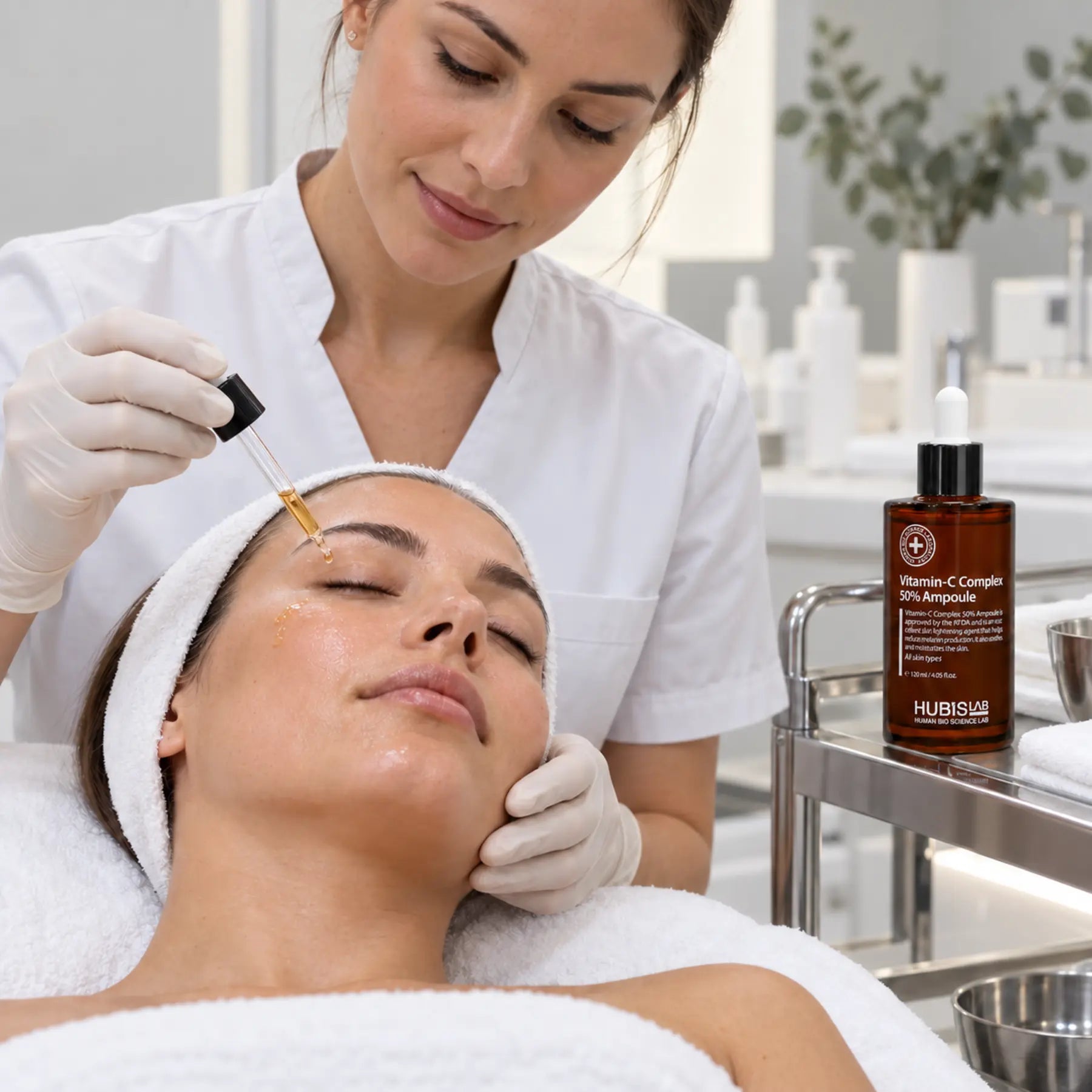 HUBISLAB Vitamin-C Complex 50% Ampoule applied during a professional brightening facial treatment.