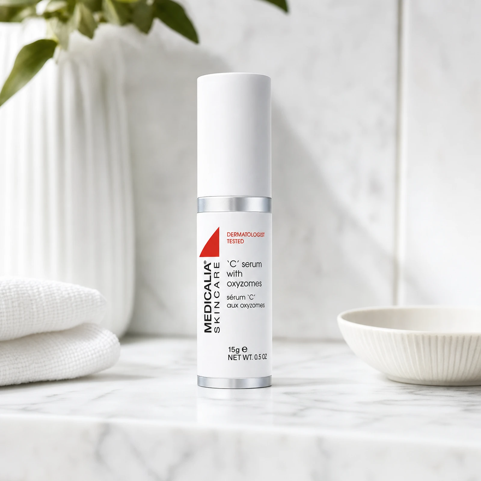 Medicalia C Serum with Oxyzomes 15ml on a premium marble bathroom vanity, a potent Vitamin C serum with oxyzome encapsulation technology for brightening, firming, and fading hyperpigmentation.