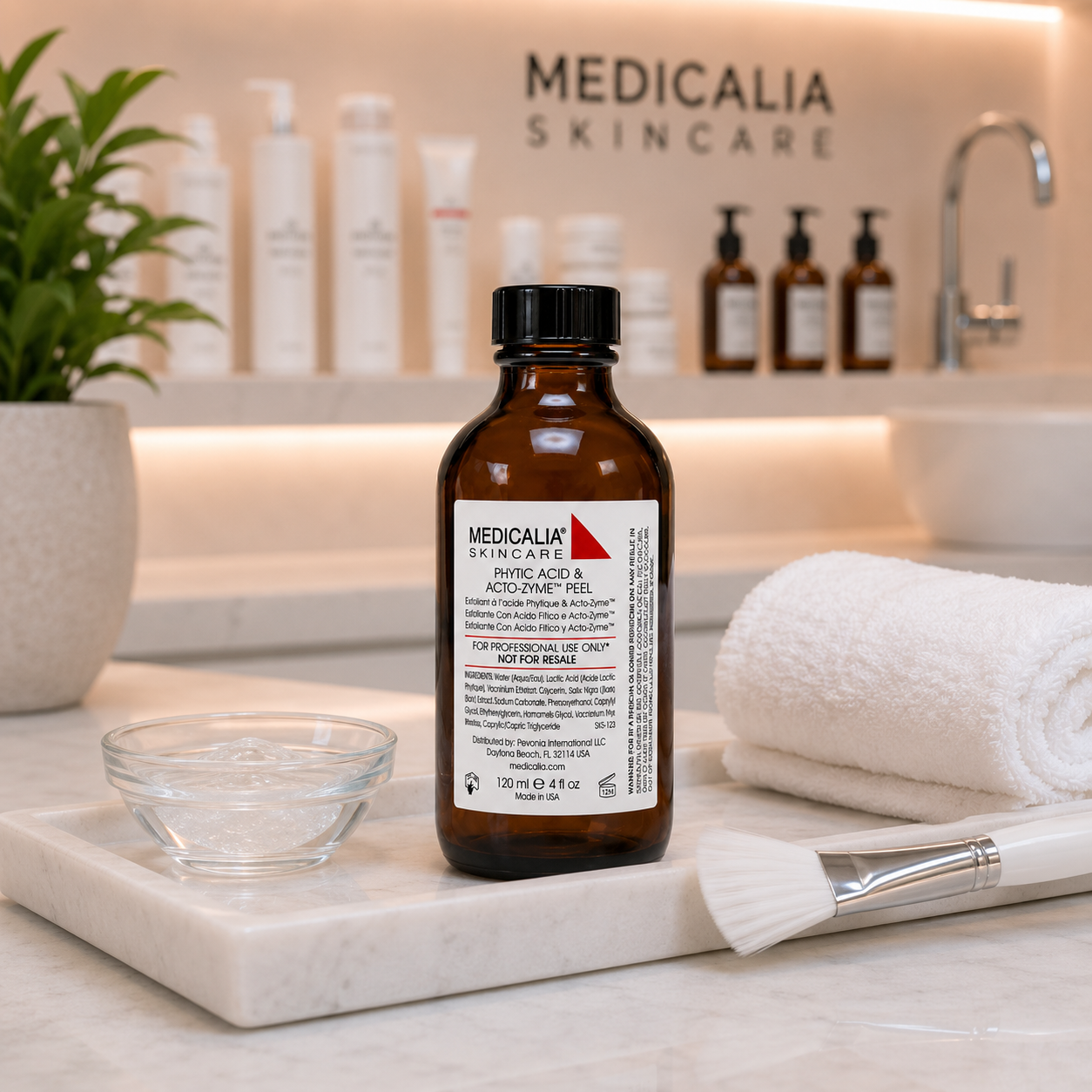 Medicalia Phytic Acid and Acto-Zyme Peel displayed on a marble clinic treatment tray with gel bowl, towel and brush in a professional facial peel treatment setting.