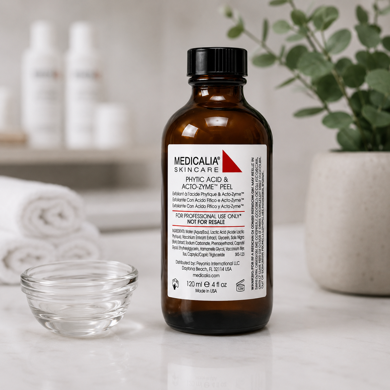 Medicalia Phytic Acid and Acto-Zyme Peel bottle beside a clear glass application jar in a professional clinic setting.