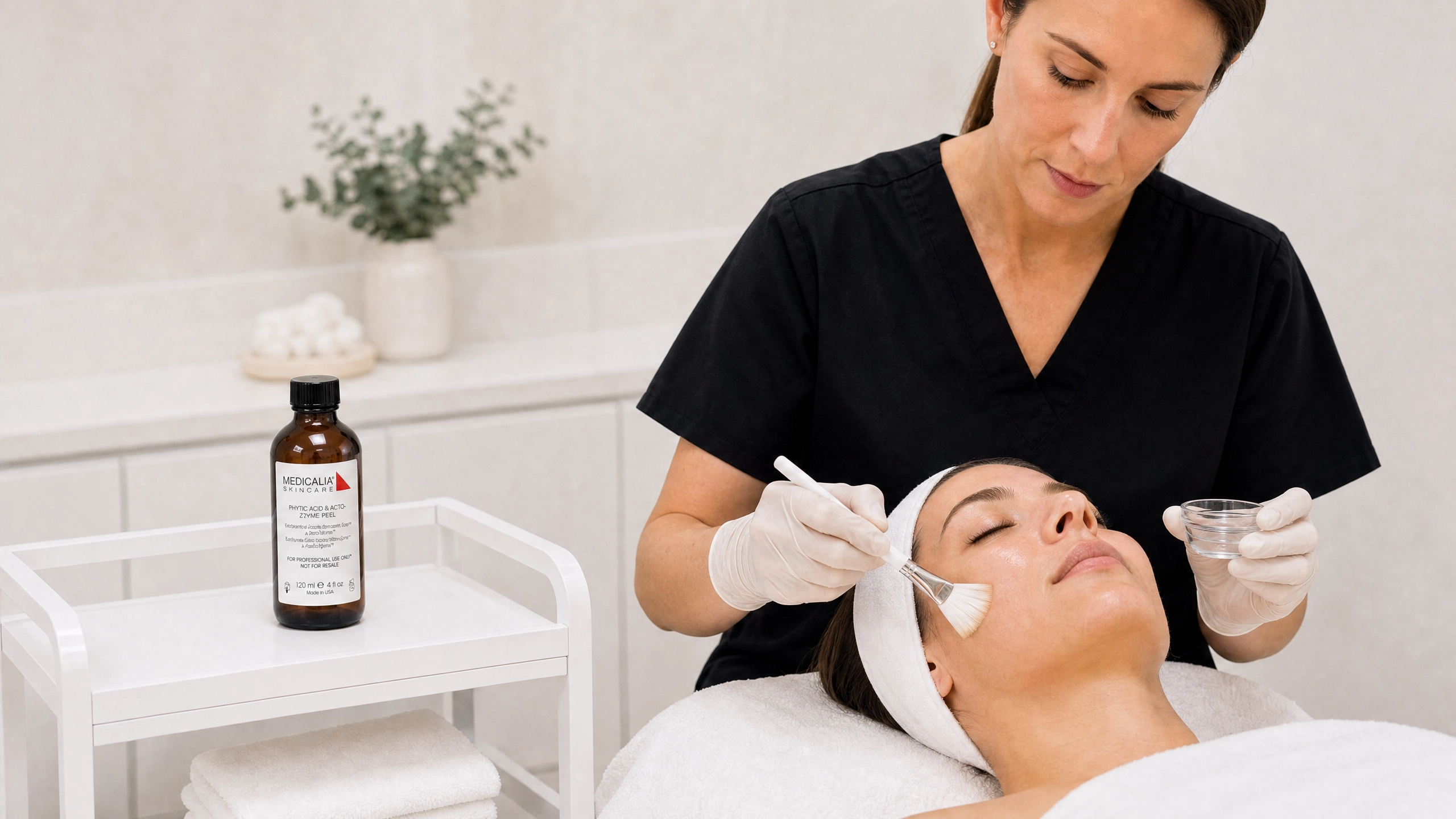 Medicalia Phytic Acid and Acto-Zyme Peel professional treatment application with therapist applying peel in a medi-clinic setting.