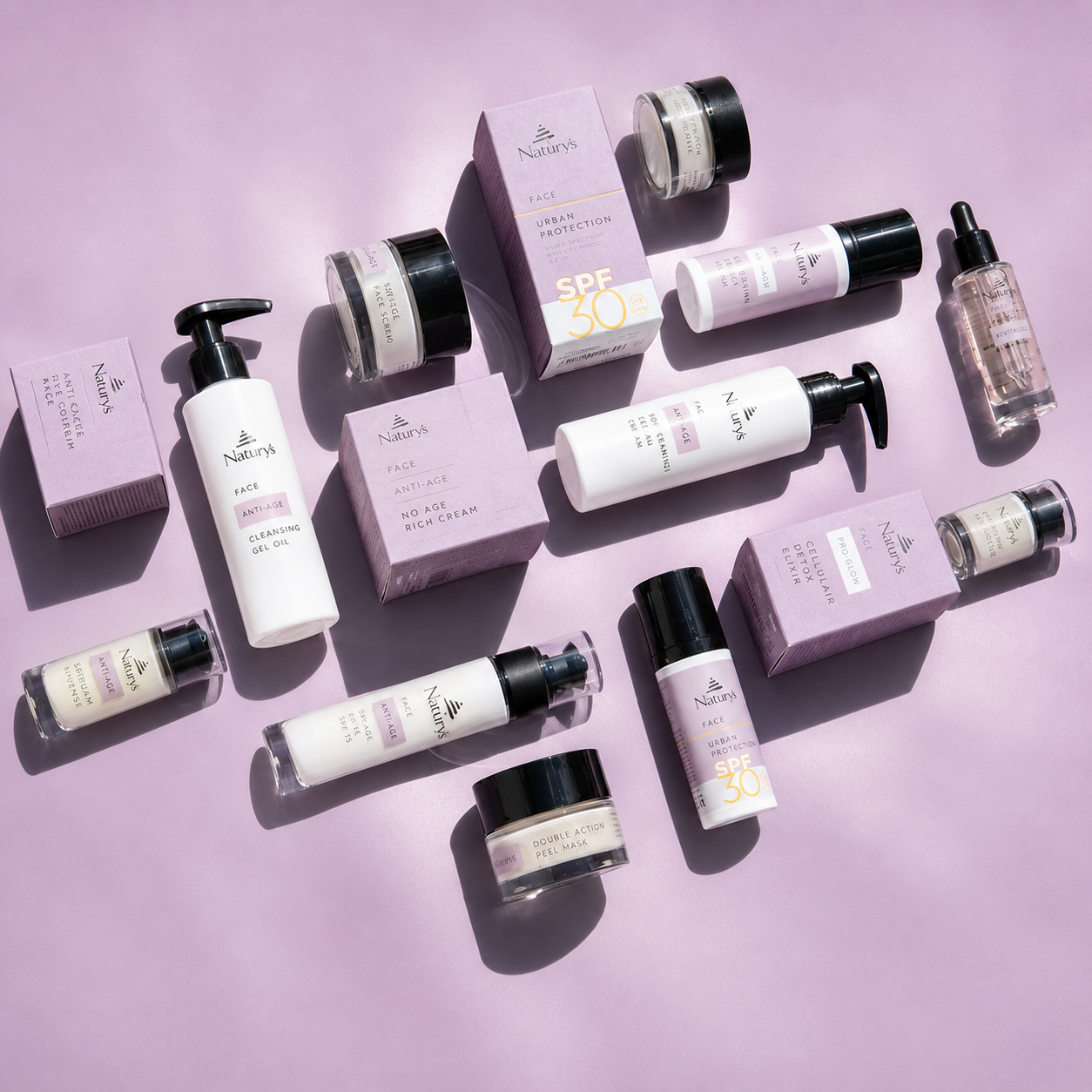 Naturys Face Anti-Age skincare range flat lay featuring SPF 50 serum cleanser cream and treatment products on lavender background for mature and dehydrated skin