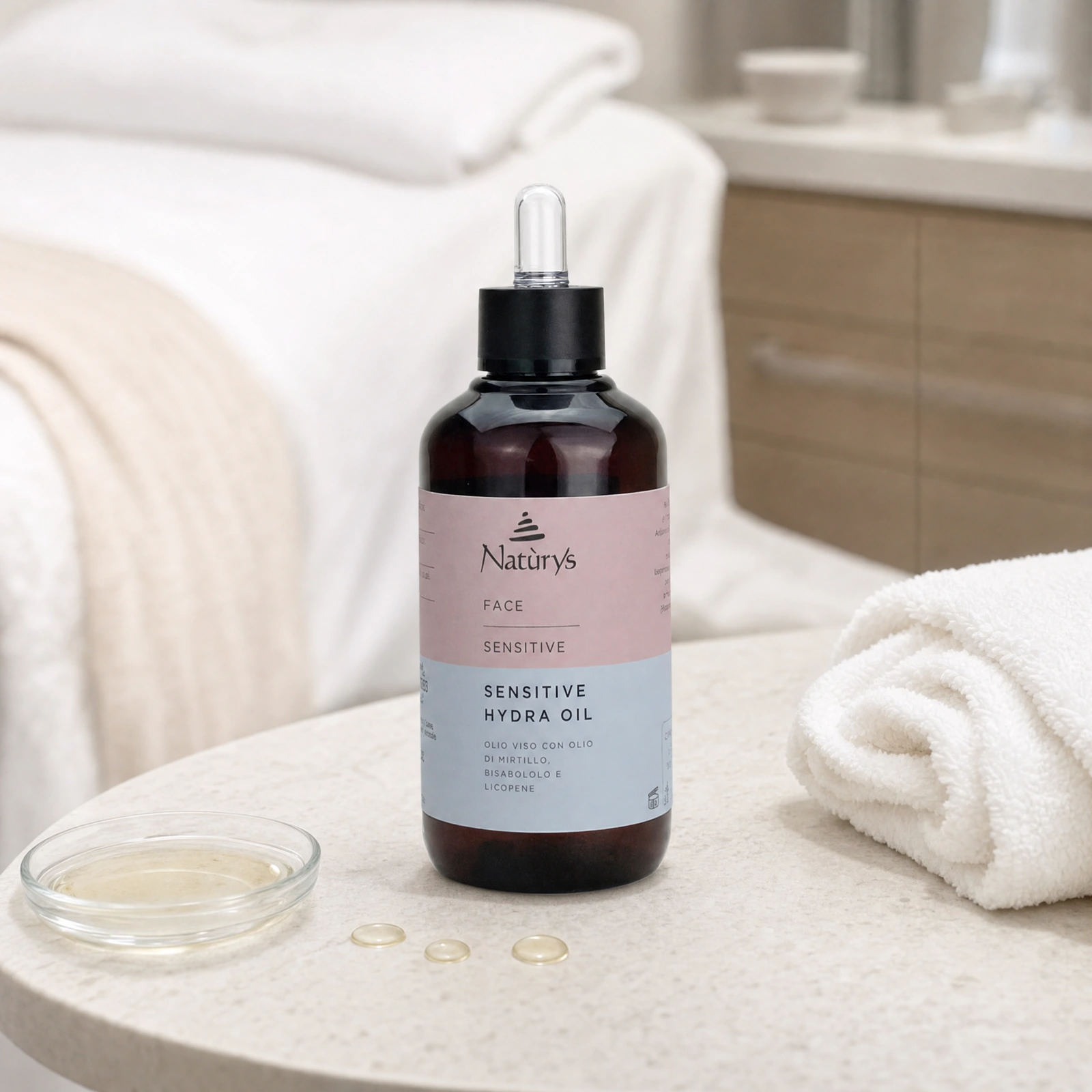 Naturys Sensitive Hydra Oil 100ml displayed in a premium clinical treatment-room setting for professional sensitive-skin calming, antioxidant and radiance protocols.