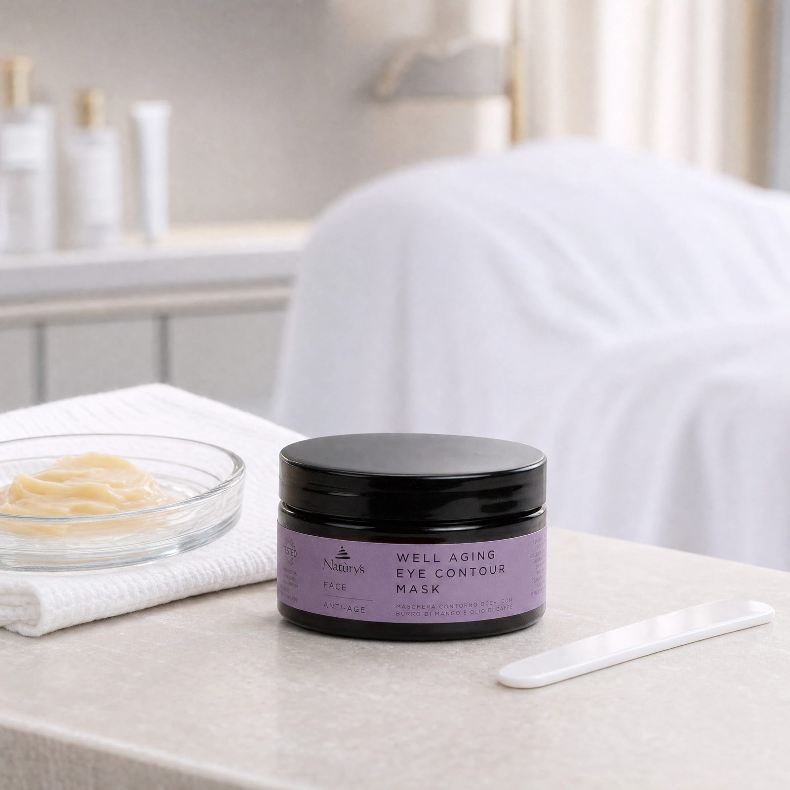 Naturys Well Aging Eye Contour Mask 100ml displayed in a premium clinical treatment-room setting for professional eye contour, puffiness and fine-line care protocols.