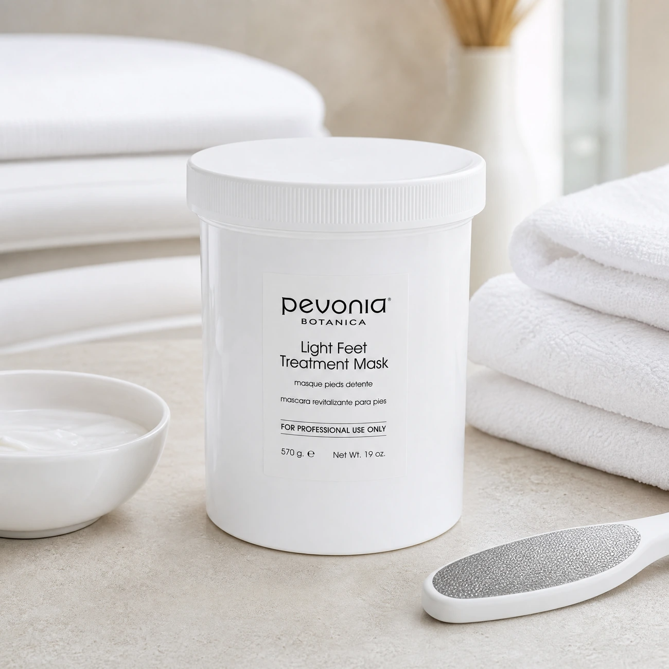 Pevonia Botanica Light Feet Treatment Mask 570g professional white tub styled in a serene clinical spa pedicure treatment room for Beauty Collective Pro.