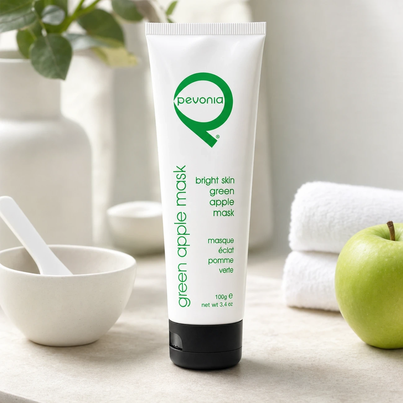 Pevonia Bright Skin Green Apple Mask 100g professional tube styled in a clean clinic treatment setting for Beauty Collective Pro.