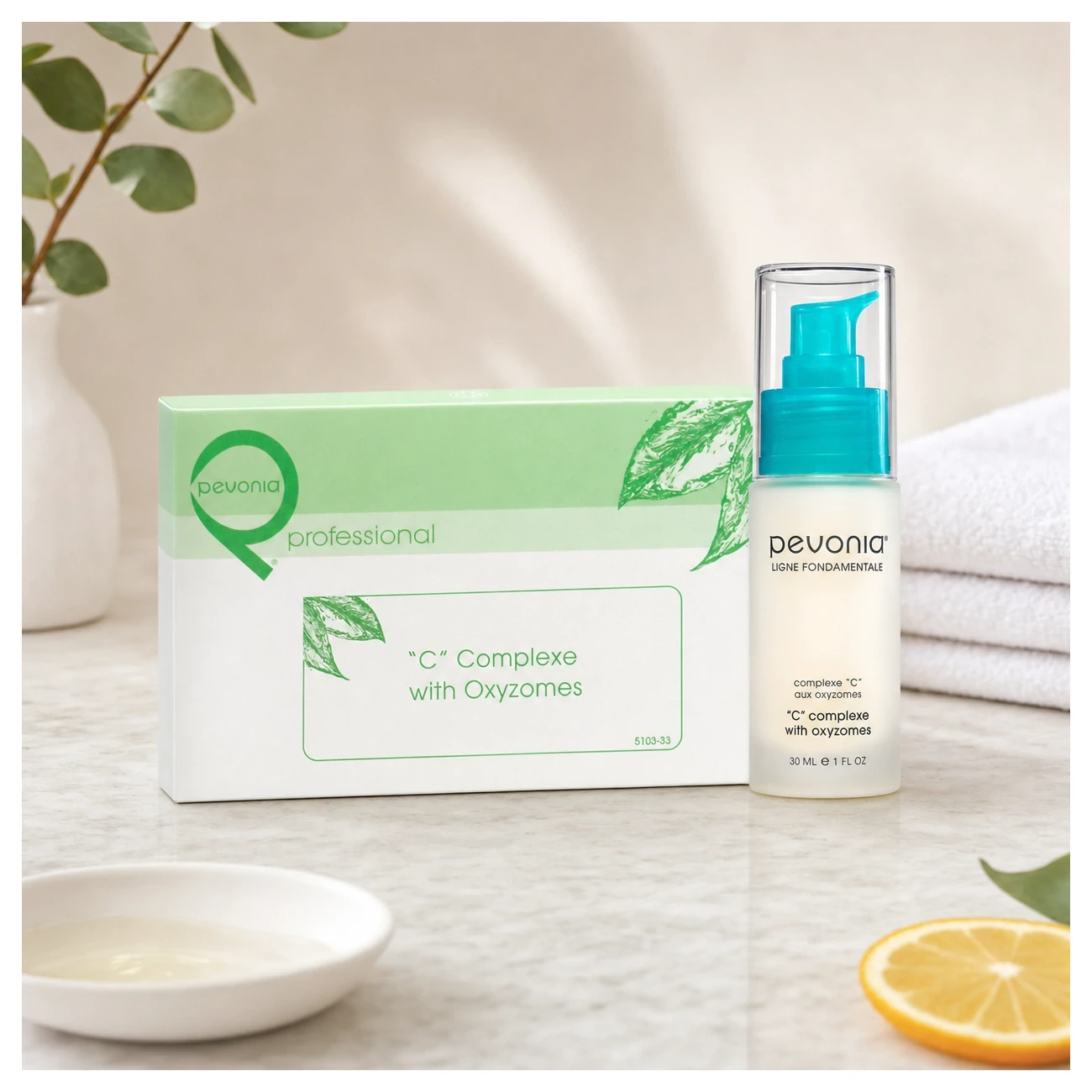 Pevonia “C” Complexe with Oxyzomes 30ml professional serum and box styled in a clean clinic treatment setting for Beauty Collective Pro.